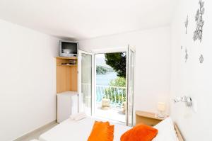 a living room with a white couch and a window at Guest House Daniela in Mlini