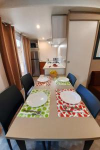 a kitchen with a table with plates on it at Holiday Home Ponente Deluxe by Interhome in Marina di Bibbona