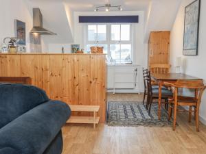 a living room with a couch and a table at The Rest in Eyemouth