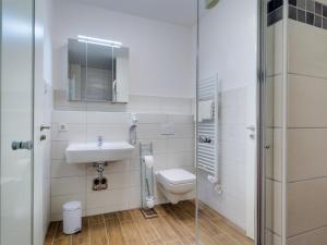 a bathroom with a toilet and a sink and a shower at Apartment Piratennest by Interhome in Großpösna
