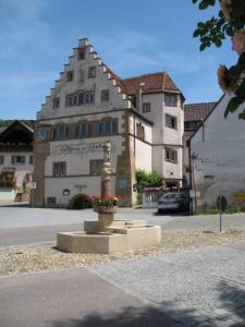 a building with a statue in front of a building at Am Weinberg - stilvoll, ruhig, zum wohlfühlen in Pfaffenweiler