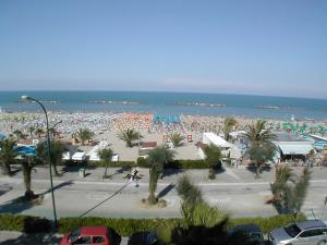 a beach with a lot of people and the ocean at Apartment Cala Luna-2 by Interhome in Porto dʼAscoli
