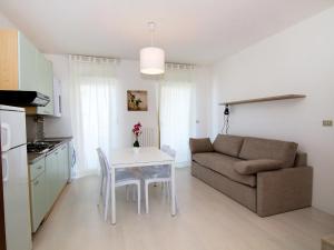 a kitchen and living room with a table and a couch at Apartment Cala Luna-2 by Interhome in Porto dʼAscoli