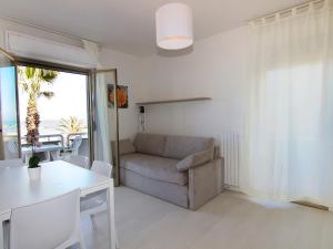 a living room with a chair and a table at Apartment Cala Luna-1 by Interhome in Porto dʼAscoli