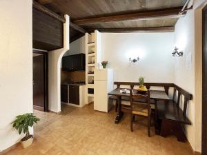 a dining room with a table and a kitchen at Holiday Home Ada by Interhome in Monte Nai