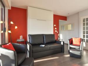 a living room with a couch and a chair at Apartment Baccara by Interhome in Deauville