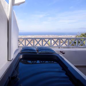 a swimming pool with a view of the ocean at Muses Cycladic Suites in Oia