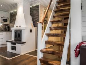 a staircase with a fireplace in a house at Holiday Home Tahkovuorentie 34 b by Interhome in Tahkovuori