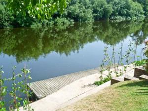a wooden walkway next to a body of water at Severn Bank Lodge in Shrawley
