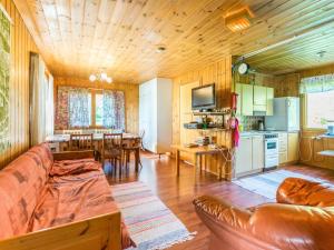 a living room with a couch and a dining room at Holiday Home Saniainen 5 by Interhome in Säviä