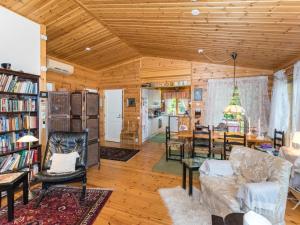 a living room filled with furniture and a dining room at Holiday Home Metsä-iivari by Interhome in Piispala