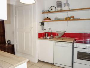 a kitchen with a sink and a stove top oven at Holiday Home La Cadièrienne by Interhome in La Cadière-dʼAzur