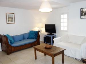 a living room with a couch and a tv at Holiday Home La Cadièrienne by Interhome in La Cadière-dʼAzur