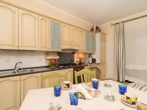 a kitchen with a table with blue cups on it at Apartment Positano Elegant Terrace by Interhome in Positano