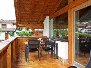 a patio with a table and chairs on a deck at Apartment Lanner by Interhome in Innsbruck