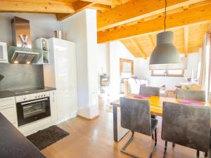 a kitchen with a dining room table and a stove at Apartment Lanner by Interhome in Innsbruck
