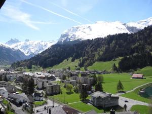 a town in a valley with snow covered mountains at Apartment Aurora by Interhome in Engelberg
