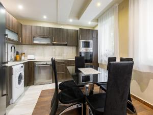 a kitchen with a table and black chairs in it at Holiday Home Sunshine by Interhome in Balatonszemes