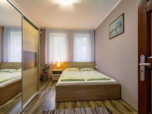 a small bedroom with two beds and a window at Holiday Home Sunshine by Interhome in Balatonszemes