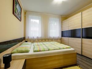 a bedroom with a bed and a window at Holiday Home Sunshine by Interhome in Balatonszemes