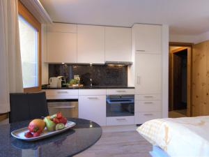 a kitchen with a plate of fruit on a table at Apartment Chesa Munteratsch 311 by Interhome in Silvaplana