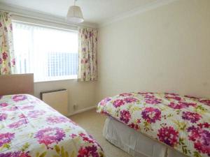 a bedroom with two beds and a window at Skylark in Holt