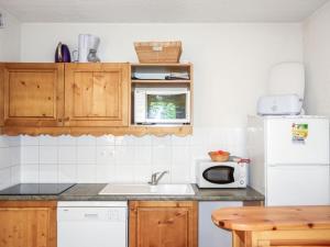 a kitchen with a sink and a microwave at Apartment Le Grand Panorama-1 by Interhome in Saint-Gervais-les-Bains