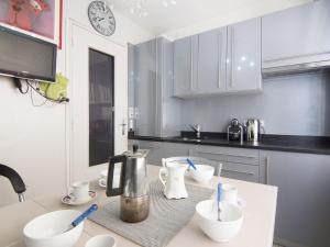 a kitchen with a counter with white bowls on it at Apartment Bellevue Clemenceau-1 by Interhome in Biarritz