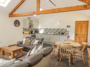 a living room with a couch and a table at Calf House in Sutton