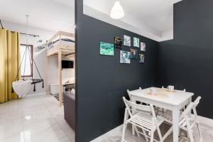 a dining room with a white table and chairs at Chill Apartments K15 Two Floor House in Warsaw