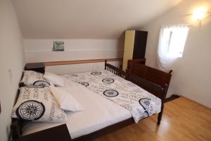 a bedroom with a bed with two pillows on it at Apartments More in Kaštela