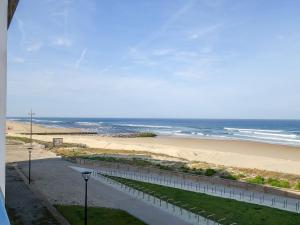 a view of a beach and the ocean from a building at Apartment Grands espaces by Interhome in Mimizan-Plage