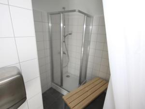 a shower with a bench in a bathroom at Apartment smart living by Interhome in Sankt Ulrich +11 photos