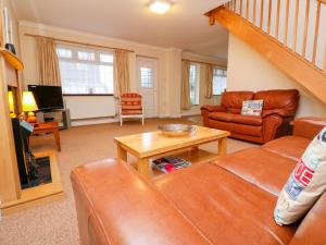a living room with a couch and a table at Tynk in Saint Merryn
