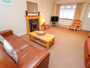 a living room with a couch and a fireplace at Tynk in Saint Merryn