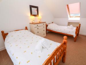 a bedroom with two twin beds and a dresser at Tynk in Saint Merryn