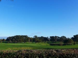 a view of a green at a golf course at Apartment Mer et Golf by Interhome in Chambre-dʼAmour