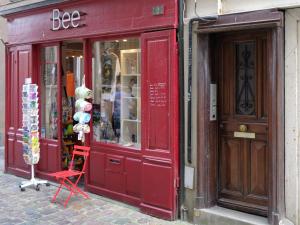 a red storefront of a store on a street at Apartment Saint Thomas by Interhome in Saint Malo