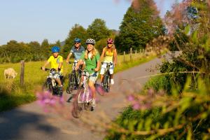 a group of people riding bikes down a road at Bed & Breakfast Weisser Stein in Schmallenberg