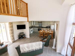 a kitchen and dining room with a table and chairs at Cilgwyn Bach in Llandysul
