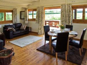 a living room with a table and a couch at Cropvale Lodge in Charlton