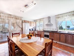 a kitchen with a wooden table with a bowl of fruit on it at Villa Macedonia by Interhome in Lloret de Mar