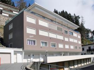 a large brown building with a lot of windows at Apartment Esther by Interhome in Davos