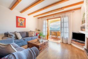 a living room with a couch and a table at Vistasol Port de Soller in Sóller