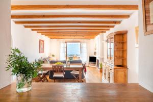a kitchen and living room with a wooden ceiling at Vistasol Port de Soller in Sóller