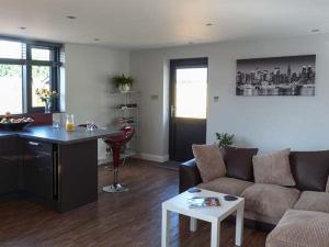 a living room with a couch and a table at The Willows in Canterbury