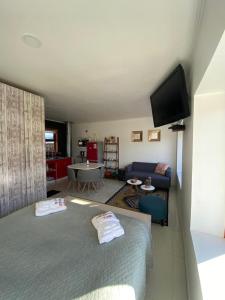 a bedroom with a bed and a living room at Departamentos KM 5 in Coihaique +69 photos