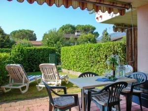 a table and chairs on a patio at Apartment App- 17 by Interhome in Caslano
