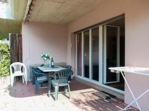 a patio with a table and chairs and a window at Apartment Caslago-2 by Interhome in Caslano