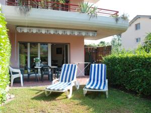 two blue and white chairs sitting in the yard at Apartment Caslago-2 by Interhome in Caslano